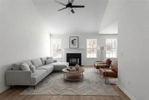 a living room with furniture and a fireplace