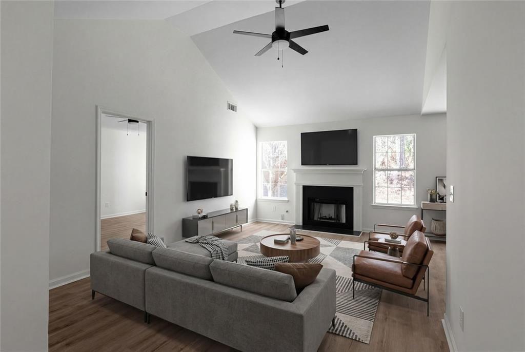 2203 Hidden Creek Drive Decatur, GA 30035 - Photo 7 of 24 a living room with furniture a flat screen tv and a fireplace