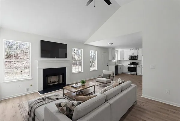 a living room with furniture a fireplace and a flat screen tv