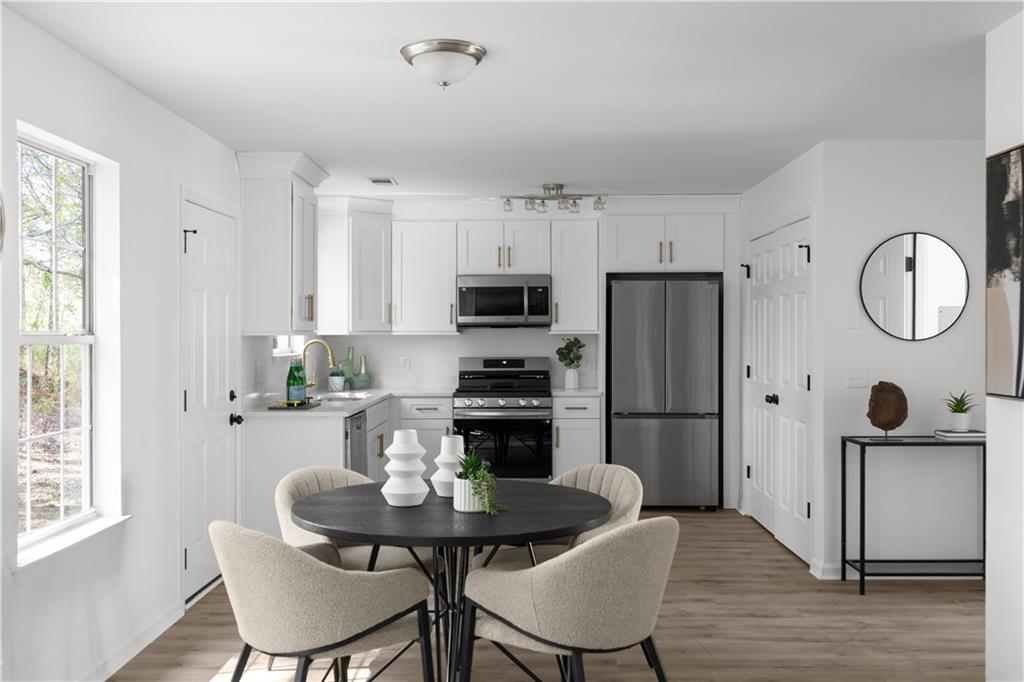 2203 Hidden Creek Drive Decatur, GA 30035 - Photo 9 of 24 a kitchen with stainless steel appliances granite countertop a dining table chairs refrigerator and sink