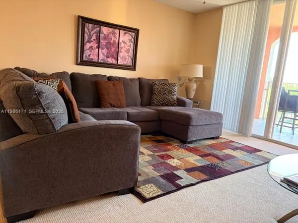 a living room with furniture and a rug