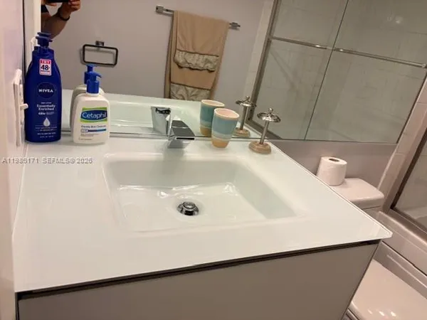 a bathroom with a sink and a mirror