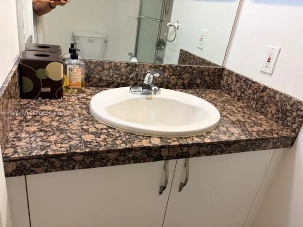 a bathroom with a sink and mirror