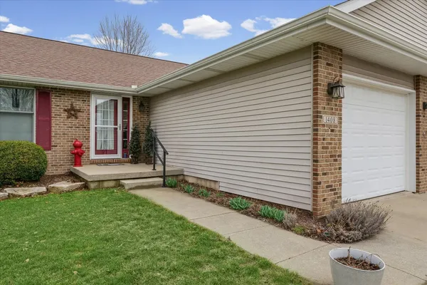 an aerial view of a house with a garden and lake view