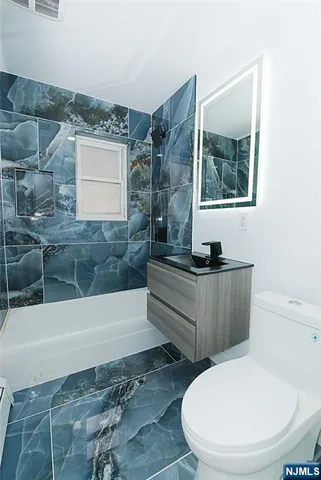 a bathroom with a toilet and a bathtub