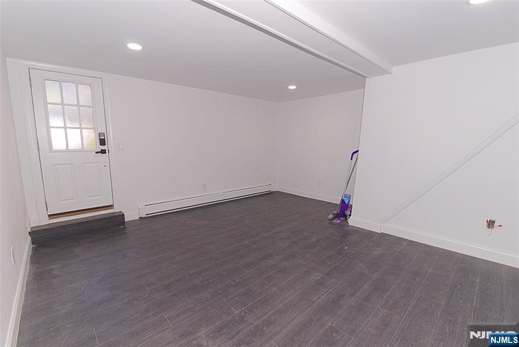 401 Undercliff Avenue Edgewater, NJ 07020 - Photo 16 of 50 an empty room with wooden floor and windows
