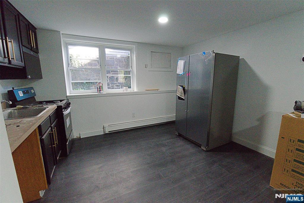 401 Undercliff Avenue Edgewater, NJ 07020 - Photo 18 of 50 a kitchen with a refrigerator and a stove top oven