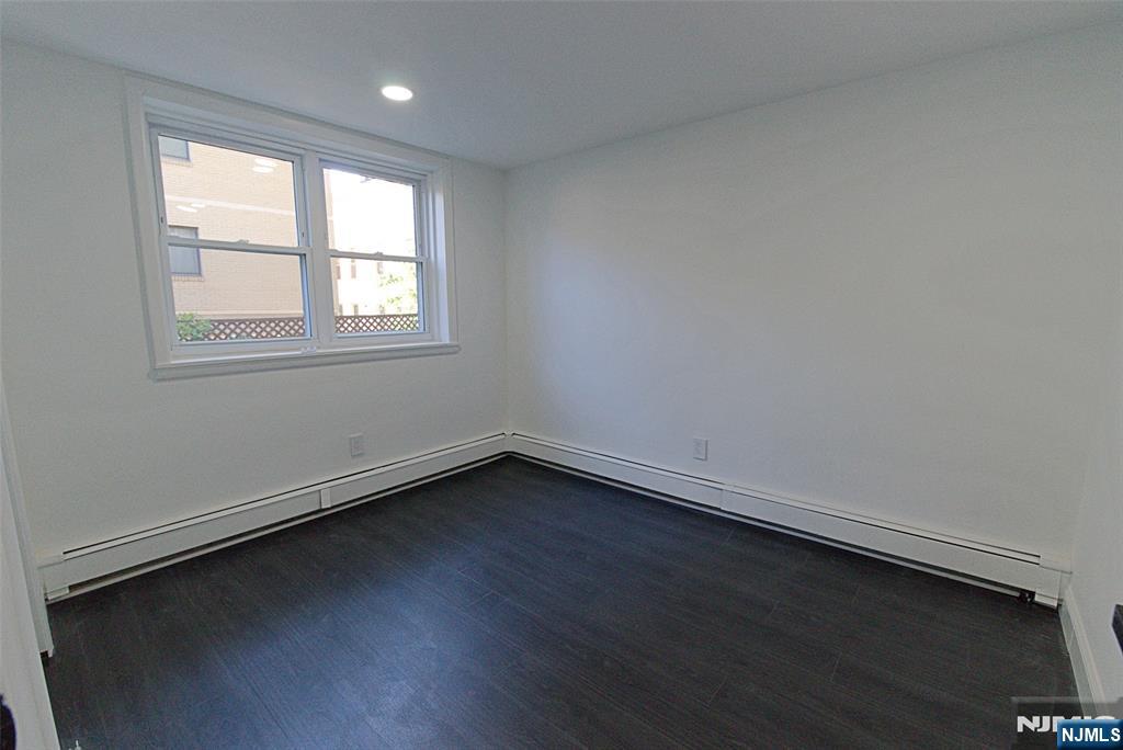 401 Undercliff Avenue Edgewater, NJ 07020 - Photo 19 of 50 an empty room with wooden floor and windows