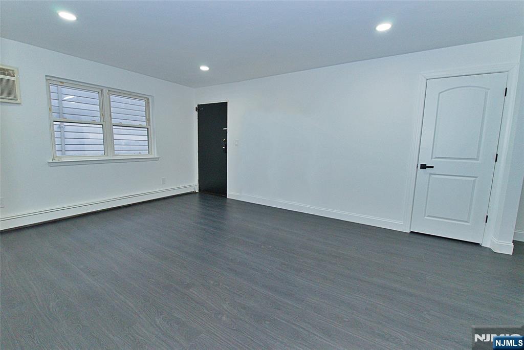 401 Undercliff Avenue Edgewater, NJ 07020 - Photo 2 of 50 an empty room with wooden floor and windows