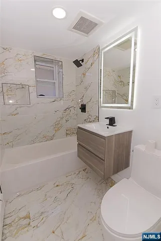 a bathroom with a sink a toilet and bathtub