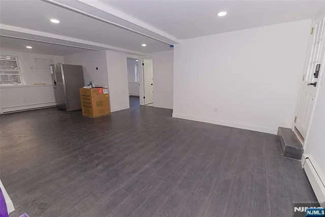 a view of a storage & utility room with closet wooden floor and windows