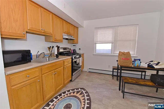 a kitchen with stainless steel appliances granite countertop a sink and cabinets