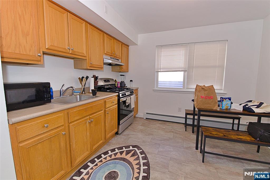 401 Undercliff Avenue Edgewater, NJ 07020 - Photo 27 of 50 a kitchen with stainless steel appliances granite countertop a sink and cabinets
