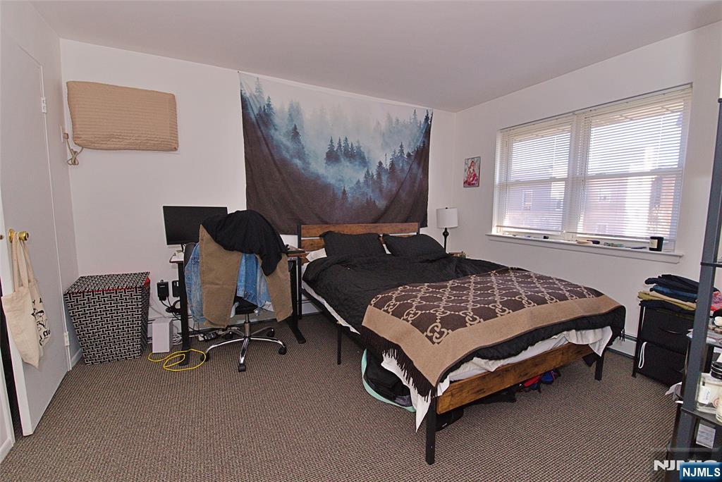 401 Undercliff Avenue Edgewater, NJ 07020 - Photo 30 of 50 a bedroom with a bed and window