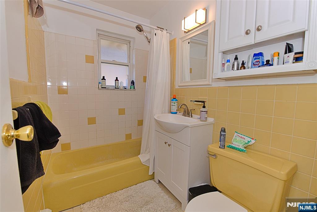 401 Undercliff Avenue Edgewater, NJ 07020 - Photo 31 of 50 a bathroom with a bathtub and a shower