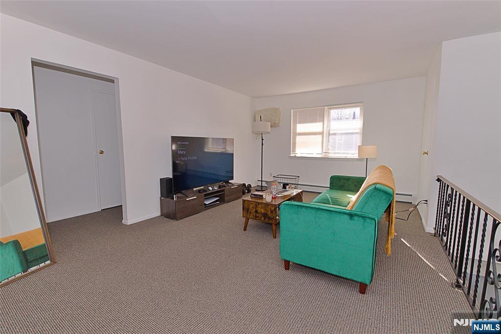 401 Undercliff Avenue Edgewater, NJ 07020 - Photo 33 of 50 a living room with furniture and a flat screen tv