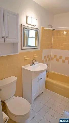 a bathroom with a sink a toilet and bathtub