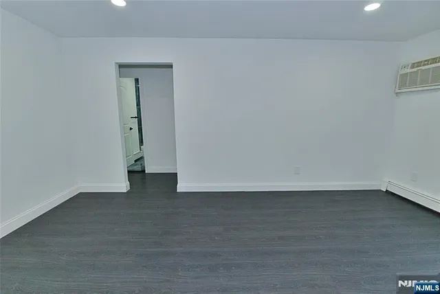 a view of an empty room and wooden floor