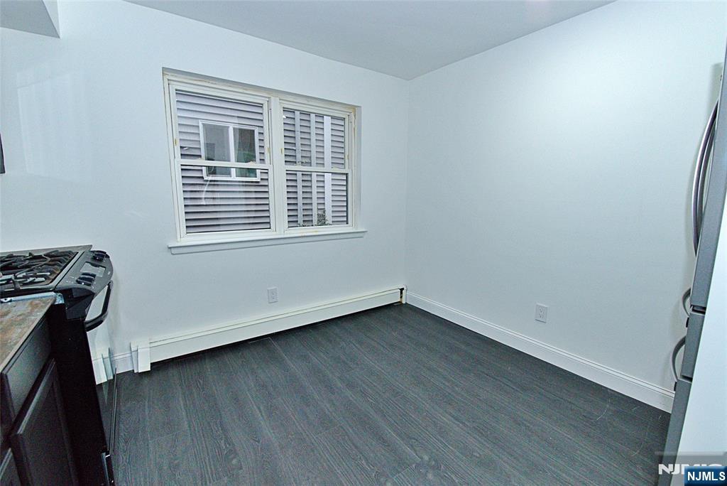 401 Undercliff Avenue Edgewater, NJ 07020 - Photo 8 of 50 an empty room with wooden floor and windows