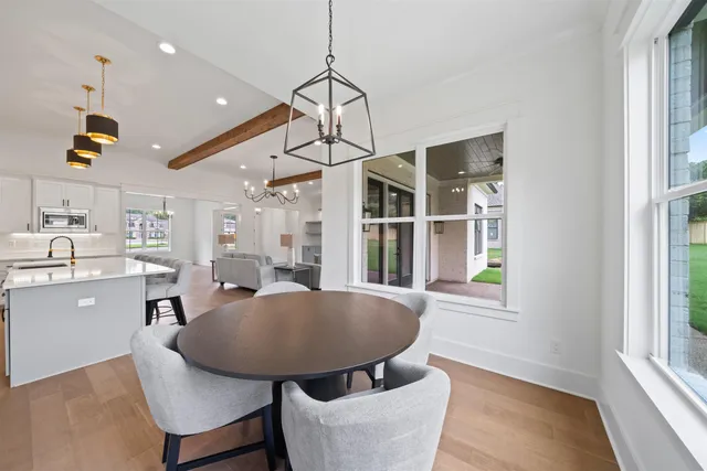 a living room with furniture a window and kitchen view