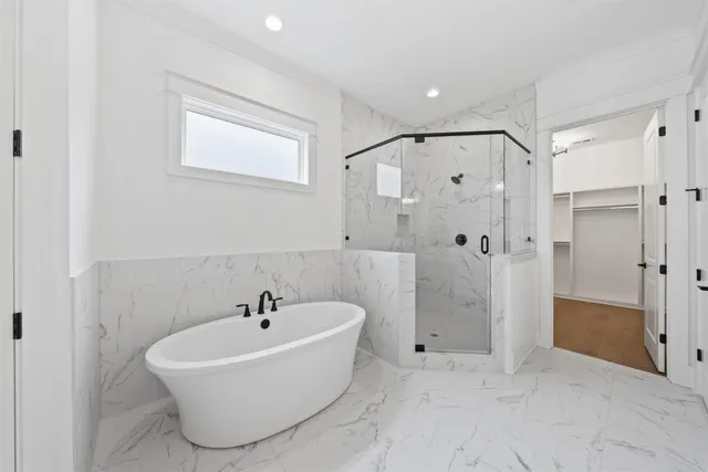 a white bath tub sitting next to a bathroom sink