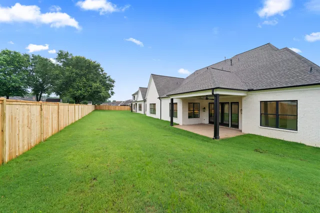 a view of a house with a yard and sitting area