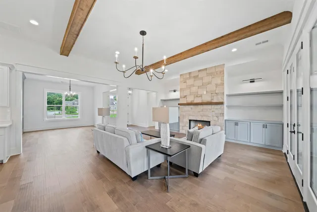 a living room with furniture and a chandelier
