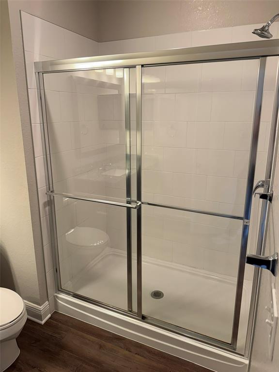 2460 Ann Rou Road, Unit 606 Tavares, FL 32778 - Photo 15 of 18 a bathroom with a glass shower door