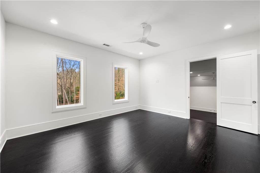 5211 Powers Ferry Road Northwest Sandy Springs, GA 30327 - Photo 94 of 106 a view of an empty room with wooden floor and a window