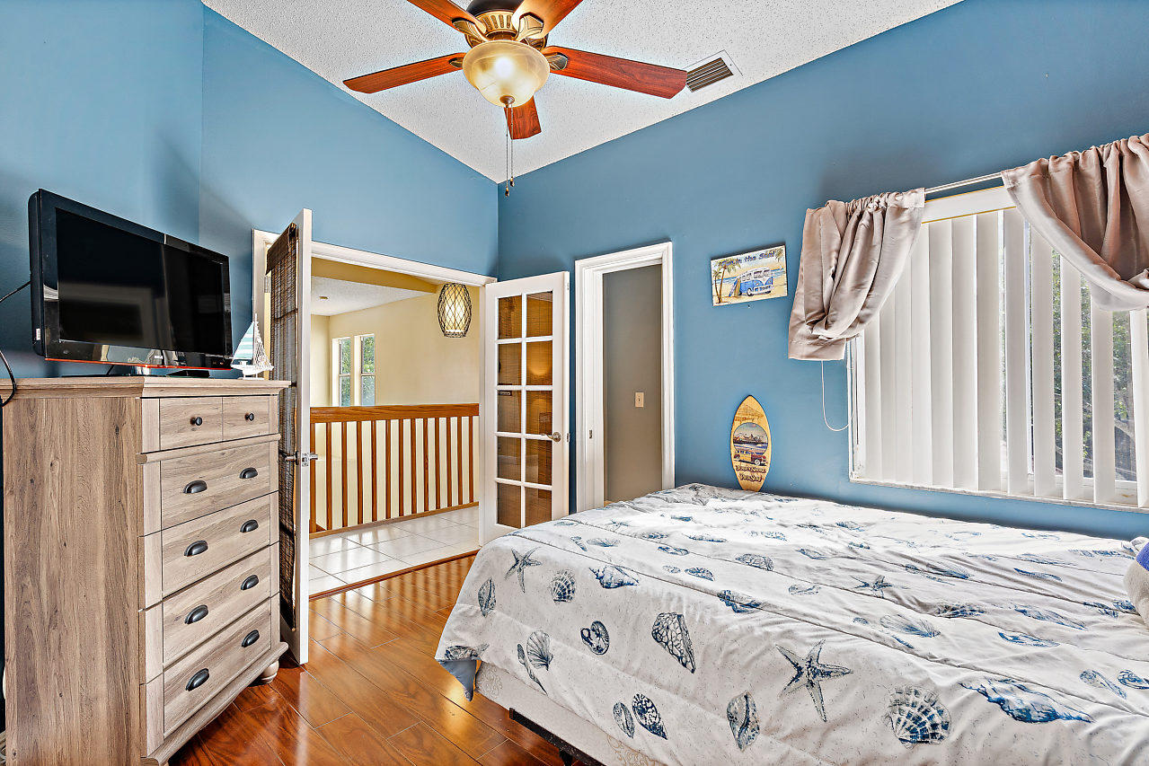 23122 Island View, Unit 6 Boca Raton, FL 33433 - Photo 18 of 38 a bedroom with a bed and a flat screen tv