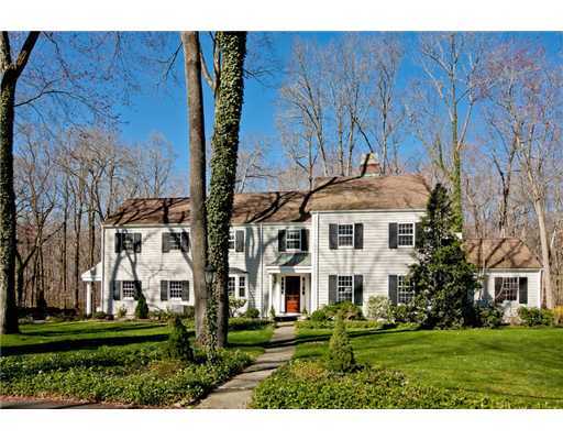 122 Colony Road Darien, CT 06820 - Photo 1 of 19 a view of a white house next to a yard with big trees