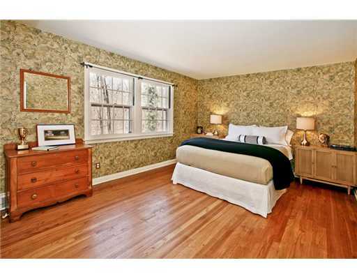 122 Colony Road Darien, CT 06820 - Photo 13 of 19 a spacious bedroom with a bed and wooden floor