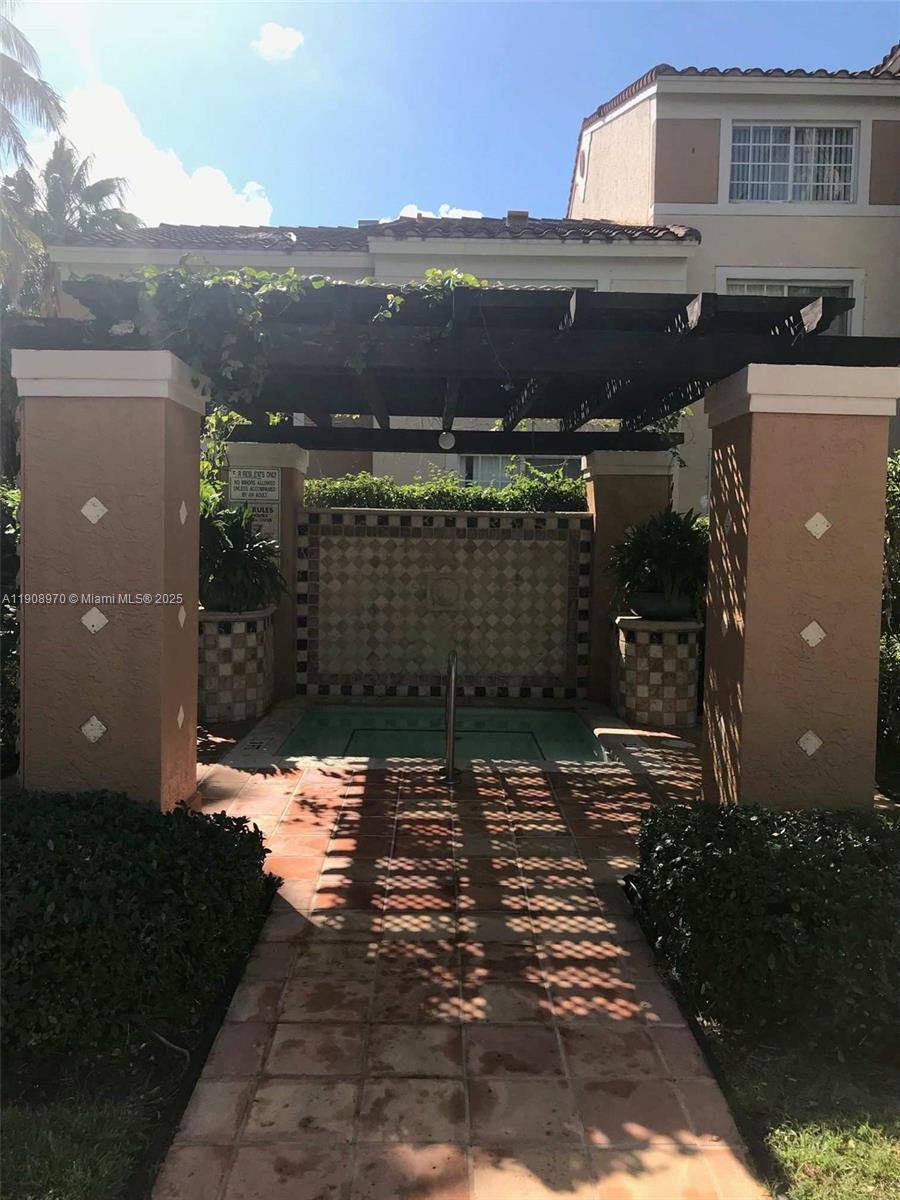2173 Renaissance Boulevard, Unit 105 Miramar, FL 33025 - Photo 12 of 16 a view of house with a garden