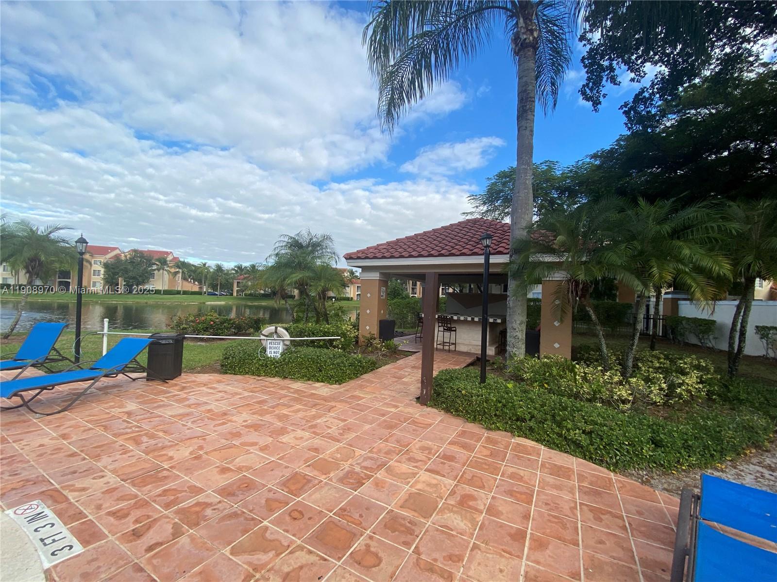 2173 Renaissance Boulevard, Unit 105 Miramar, FL 33025 - Photo 14 of 16 a view of a house with garden and a patio