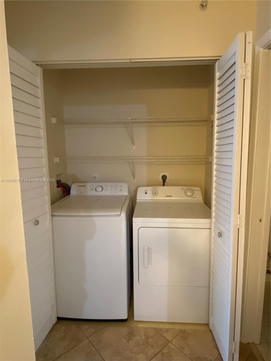 2173 Renaissance Boulevard, Unit 105 Miramar, FL 33025 - Photo 9 of 16 a utility room with dryer and washer