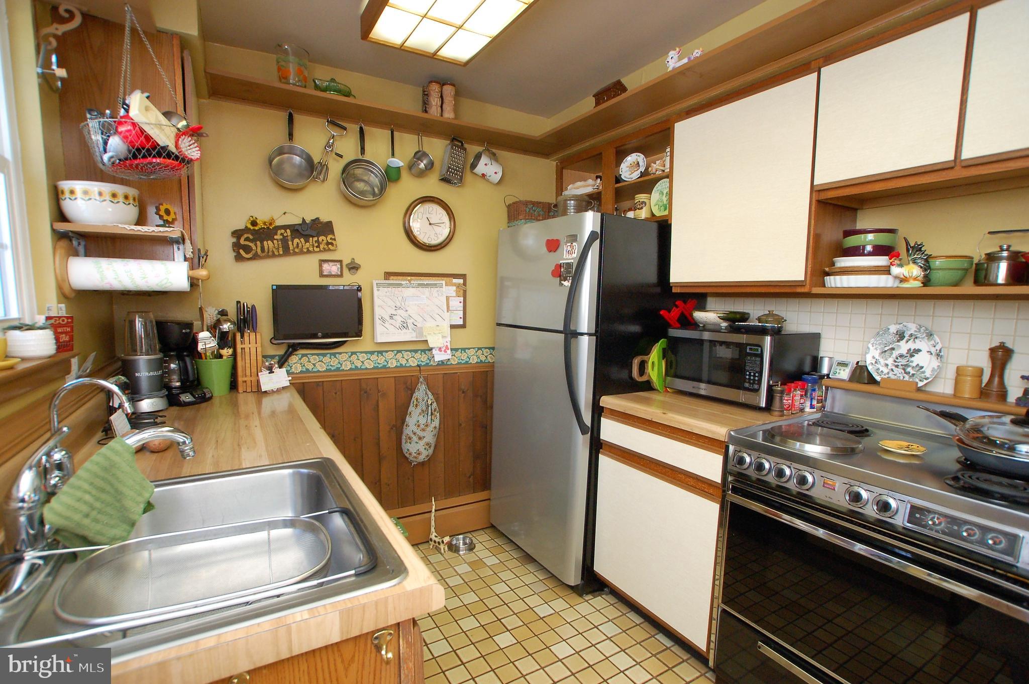 1005 Kingston Road Baltimore, MD 21208 - Photo 11 of 45 a kitchen with stainless steel appliances granite countertop a sink and a refrigerator