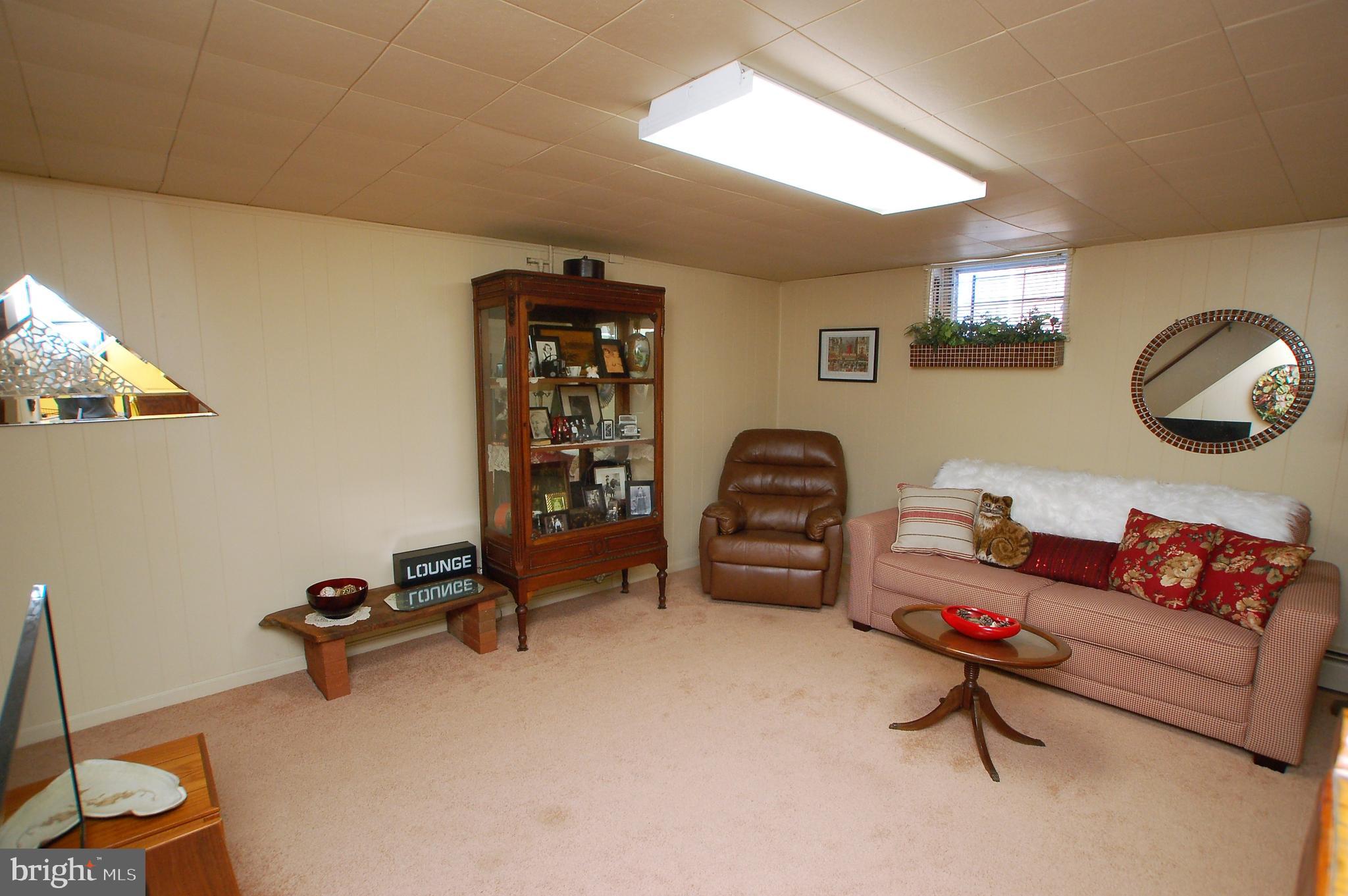 1005 Kingston Road Baltimore, MD 21208 - Photo 29 of 45 a living room with furniture a air conditioner vent and a window