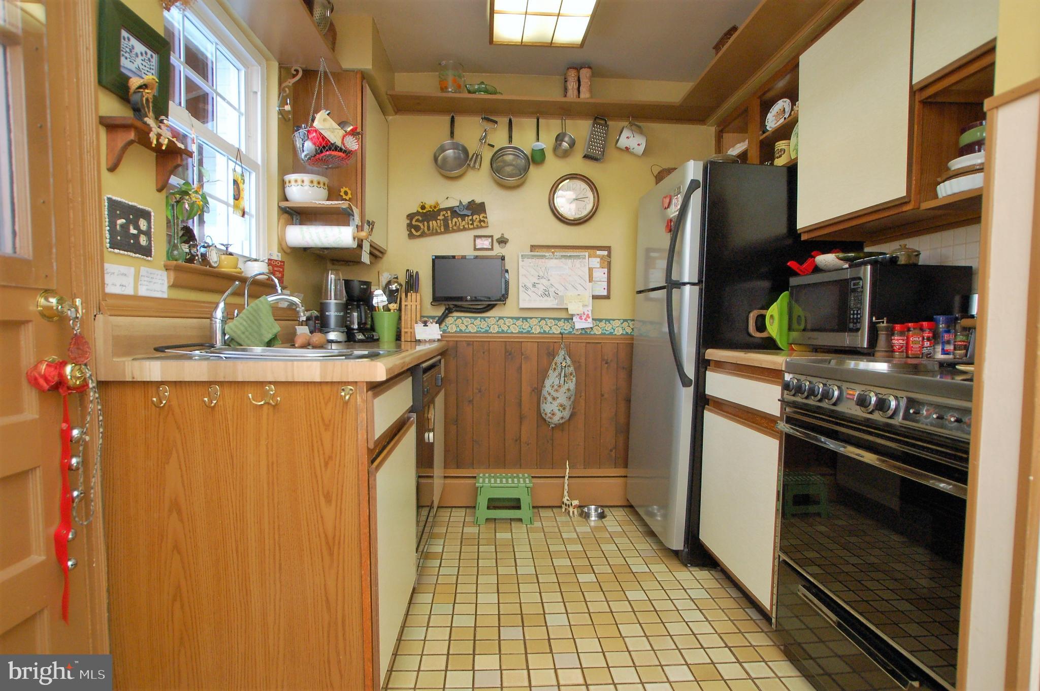 1005 Kingston Road Baltimore, MD 21208 - Photo 10 of 45 a kitchen with stainless steel appliances granite countertop a stove and a refrigerator
