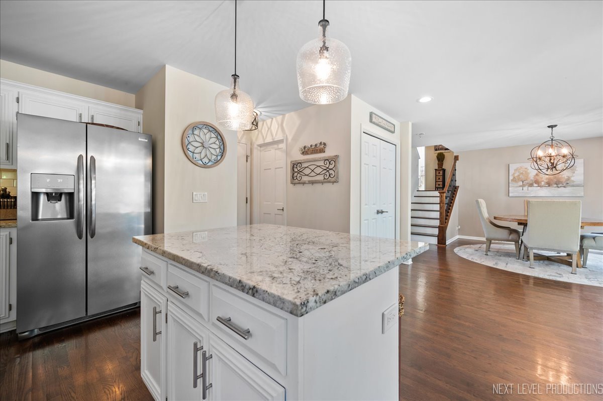 710 Hampton Course West Chicago, IL 60185 - Photo 13 of 28 a kitchen with stainless steel appliances granite countertop cabinets and wooden floor
