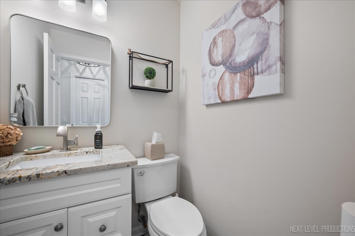 710 Hampton Course West Chicago, IL 60185 - Photo 14 of 28 a bathroom with a toilet a sink and mirror