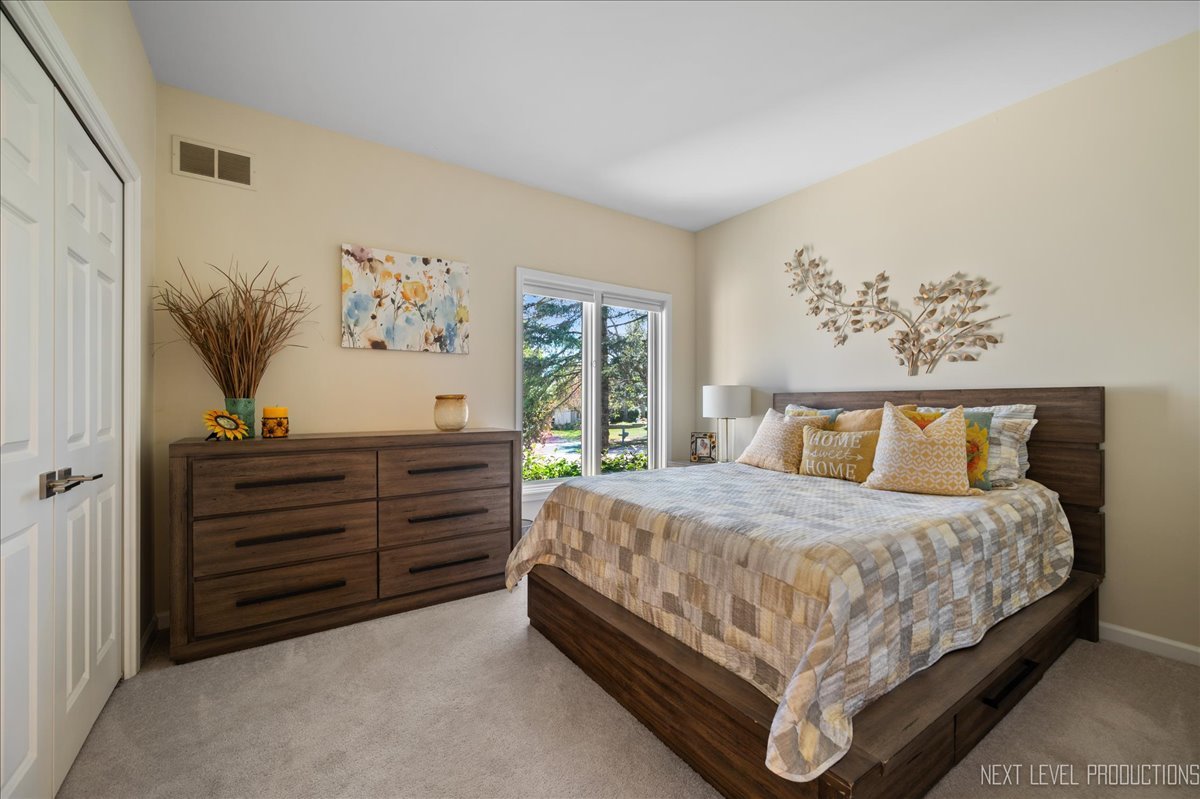 710 Hampton Course West Chicago, IL 60185 - Photo 17 of 28 a bedroom with a bed and a window