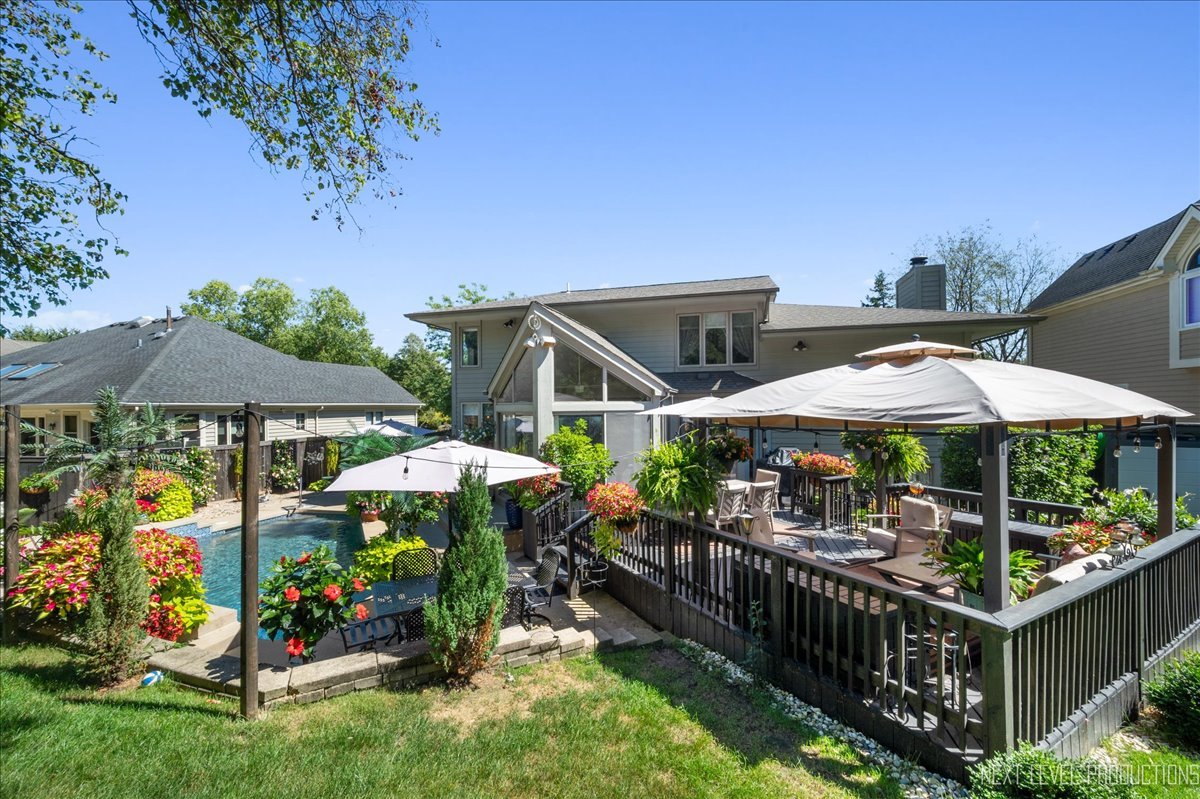 710 Hampton Course West Chicago, IL 60185 - Photo 28 of 28 a view of a chairs and table under an umbrella in backyard