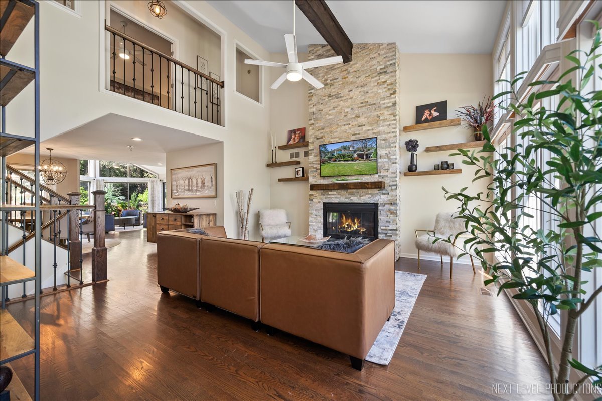 710 Hampton Course West Chicago, IL 60185 - Photo 6 of 28 a living room with furniture a fireplace and a flat screen tv