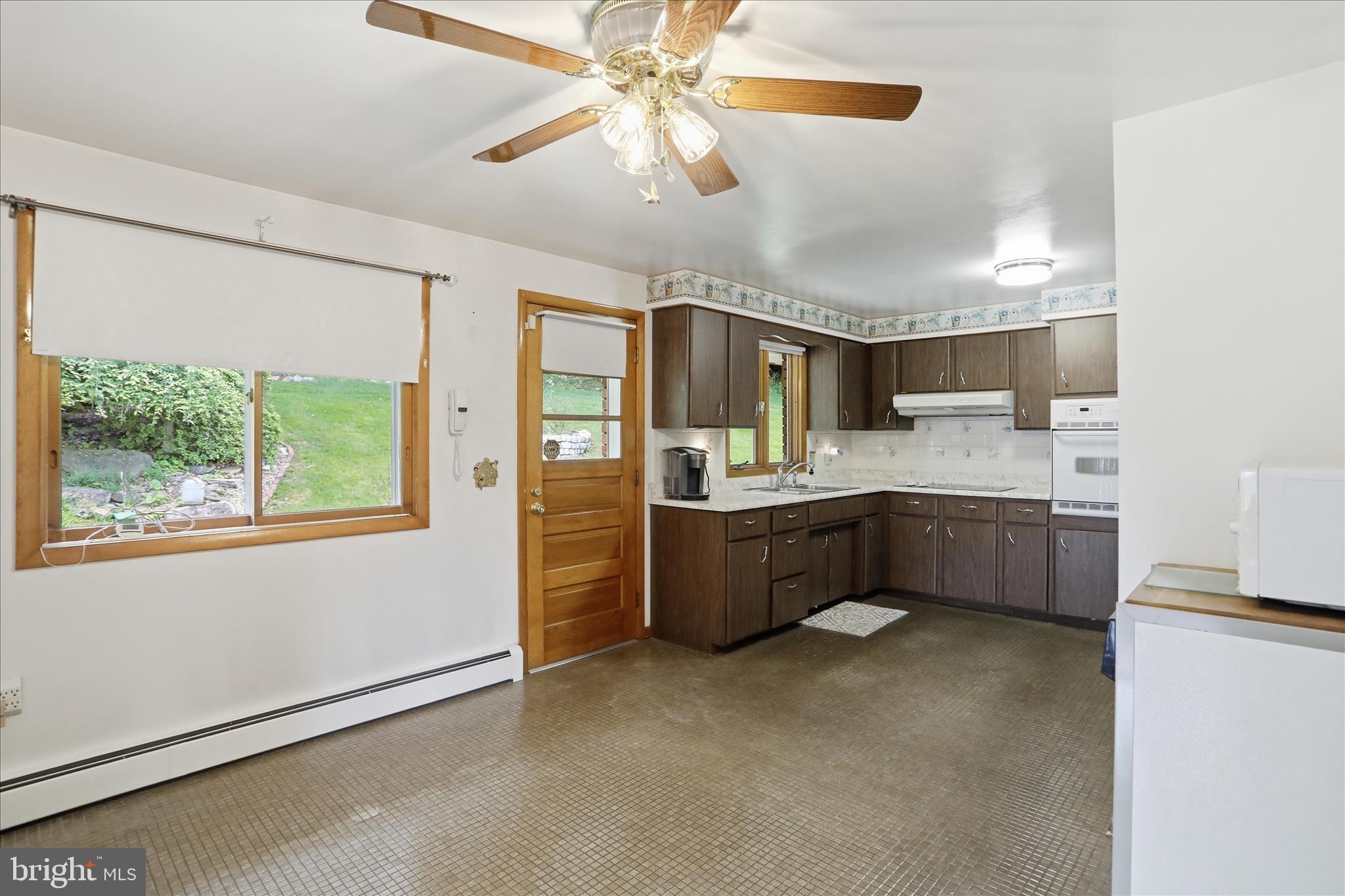 199 Buser Street Ridgeley, WV 26753 - Photo 8 of 49 a kitchen with a refrigerator a sink cabinets and a window