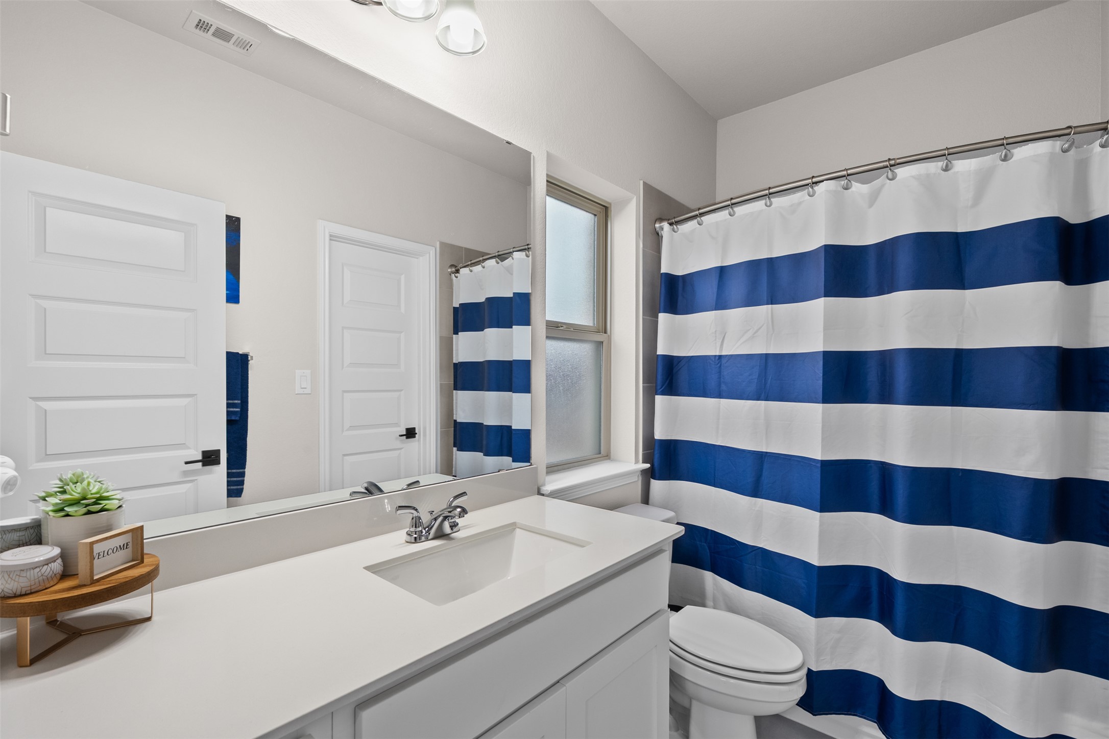 341 Pisa Lane Georgetown, TX 78628 - Photo 8 of 31 a bathroom with a sink a toilet a shower curtain