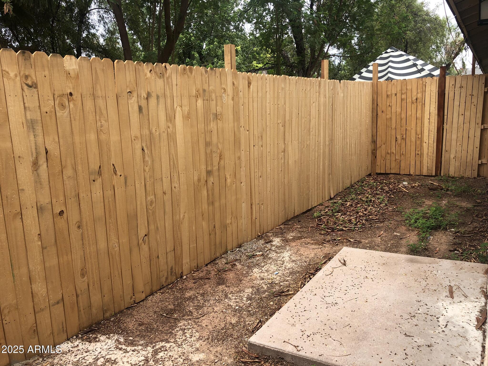 520 West Clark Street, Unit 8 Mesa, AZ 85201 - Photo 2 of 7 a view of a backyard with wooden fence
