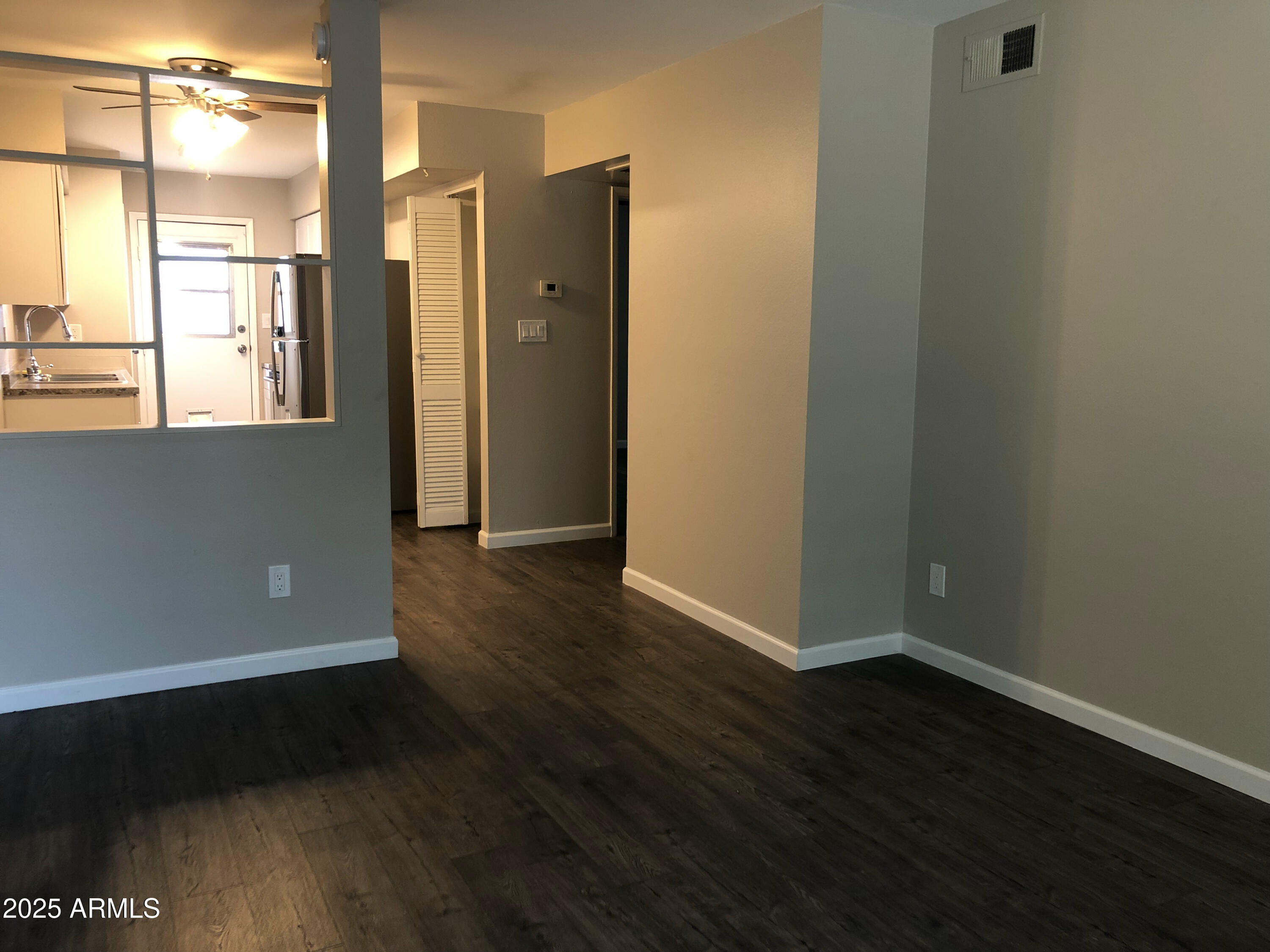 520 West Clark Street, Unit 8 Mesa, AZ 85201 - Photo 6 of 7 an empty room with wooden floor and windows
