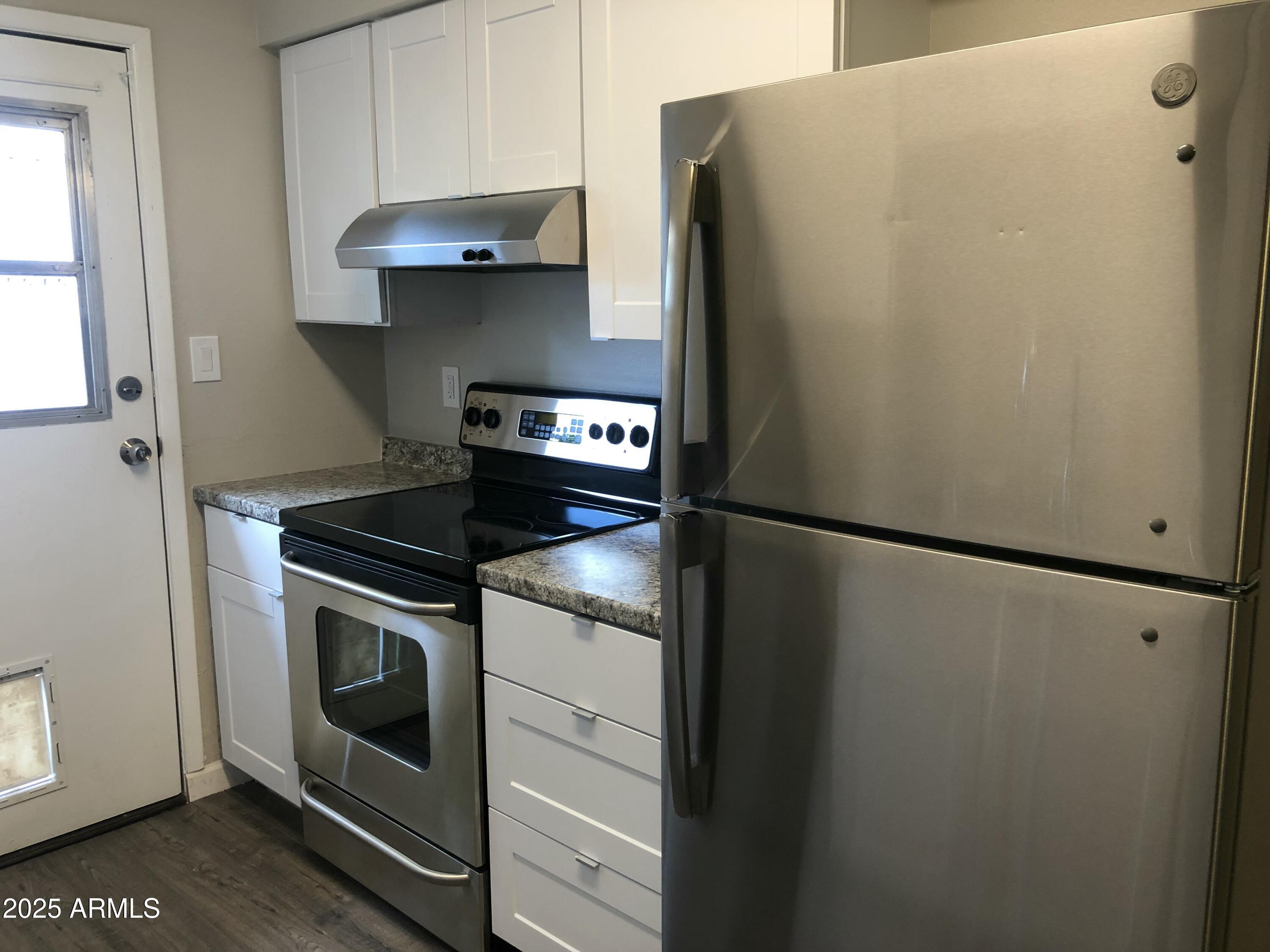 520 West Clark Street, Unit 8 Mesa, AZ 85201 - Photo 7 of 7 a kitchen with stainless steel appliances a refrigerator and a stove