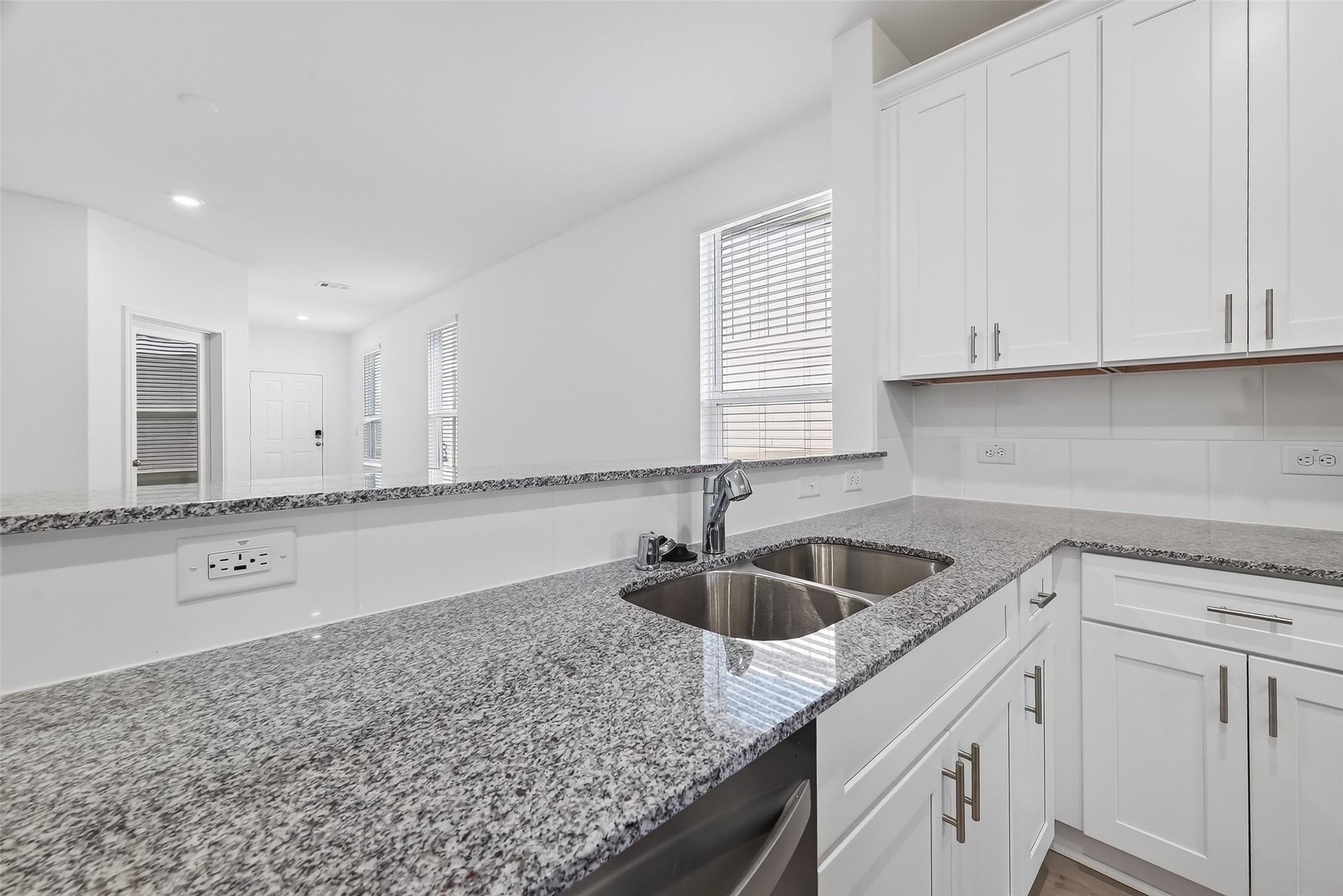 17902 Slurry Rake Lane Hockley, TX 77447 - Photo 16 of 32 a kitchen with granite countertop white cabinets and a sink