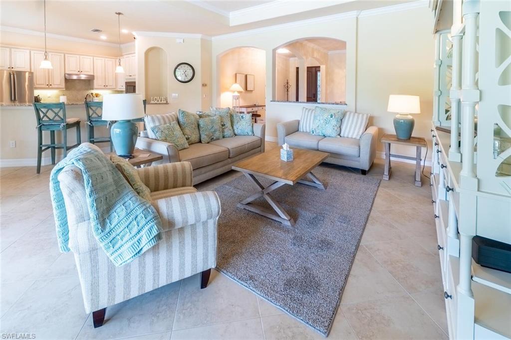 9372 Vercelli Court Naples, FL 34113 - Photo 14 of 50 Tiled living room featuring ornamental molding